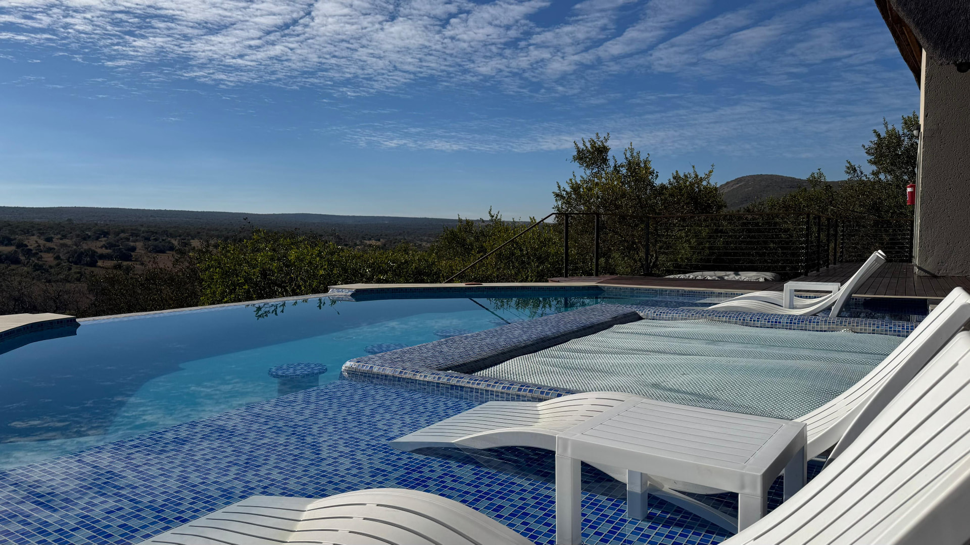 Infinity pool and white sun loungers at Tebuah Private Lodge overlooking the Waterberg bushveld