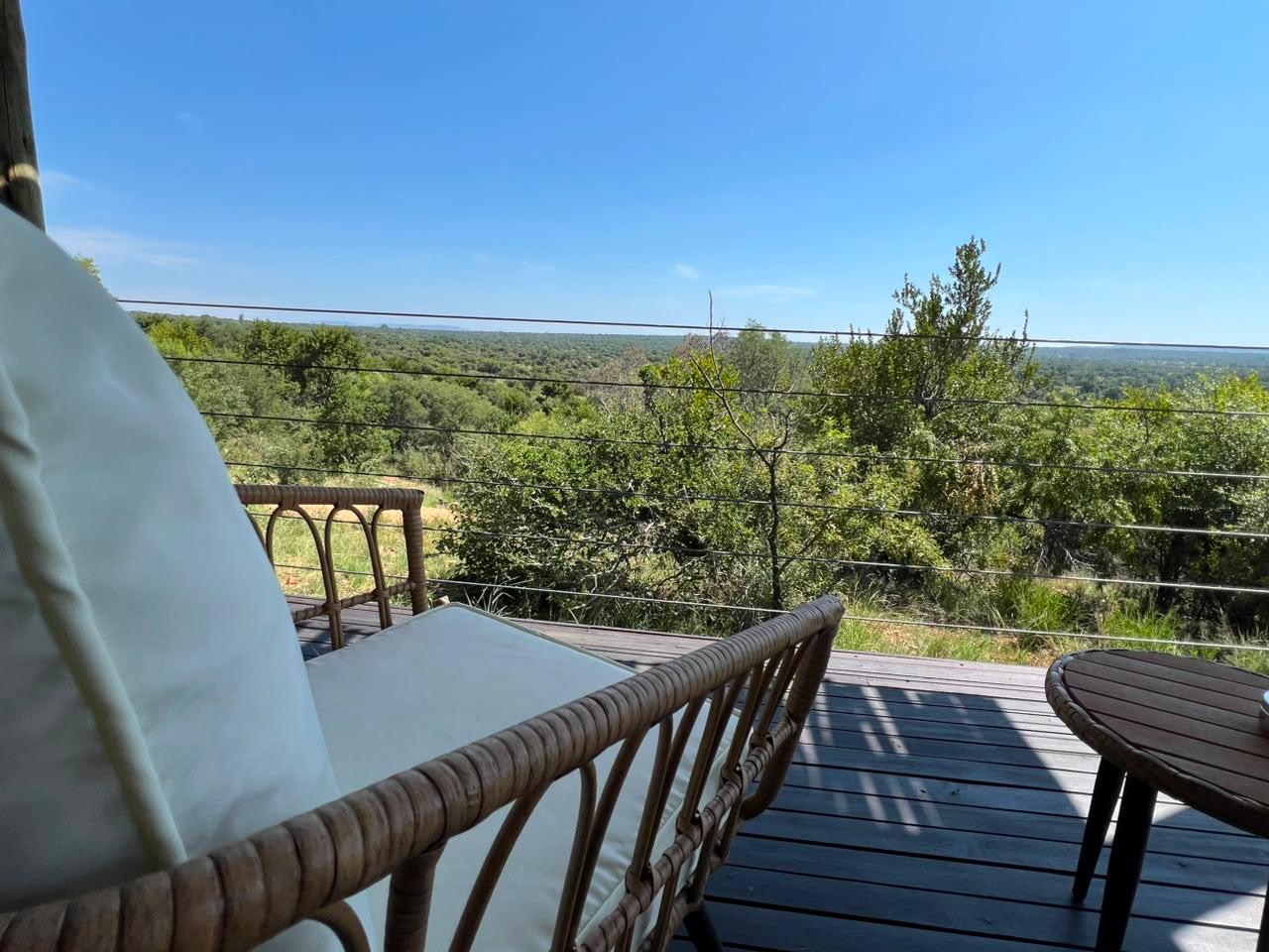 Cane deck seating looking out over the green bushveld at Sithrah Lodge