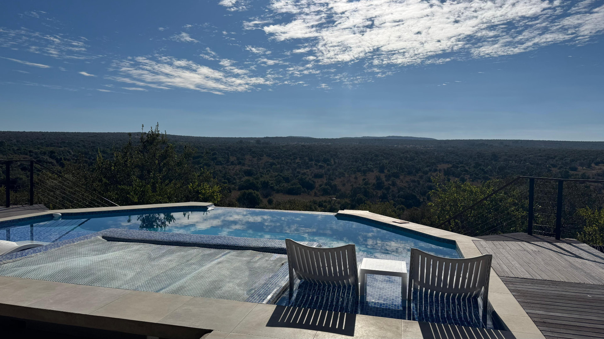 Pool edge and loungers at Tebuah Private Lodge looking across the open Waterberg valley