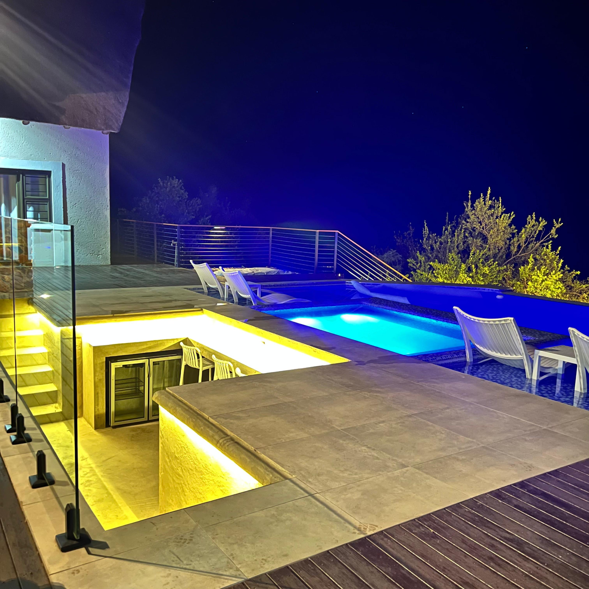 Sunken swim-up bar lit at night beside the pool at Tebuah Private Lodge