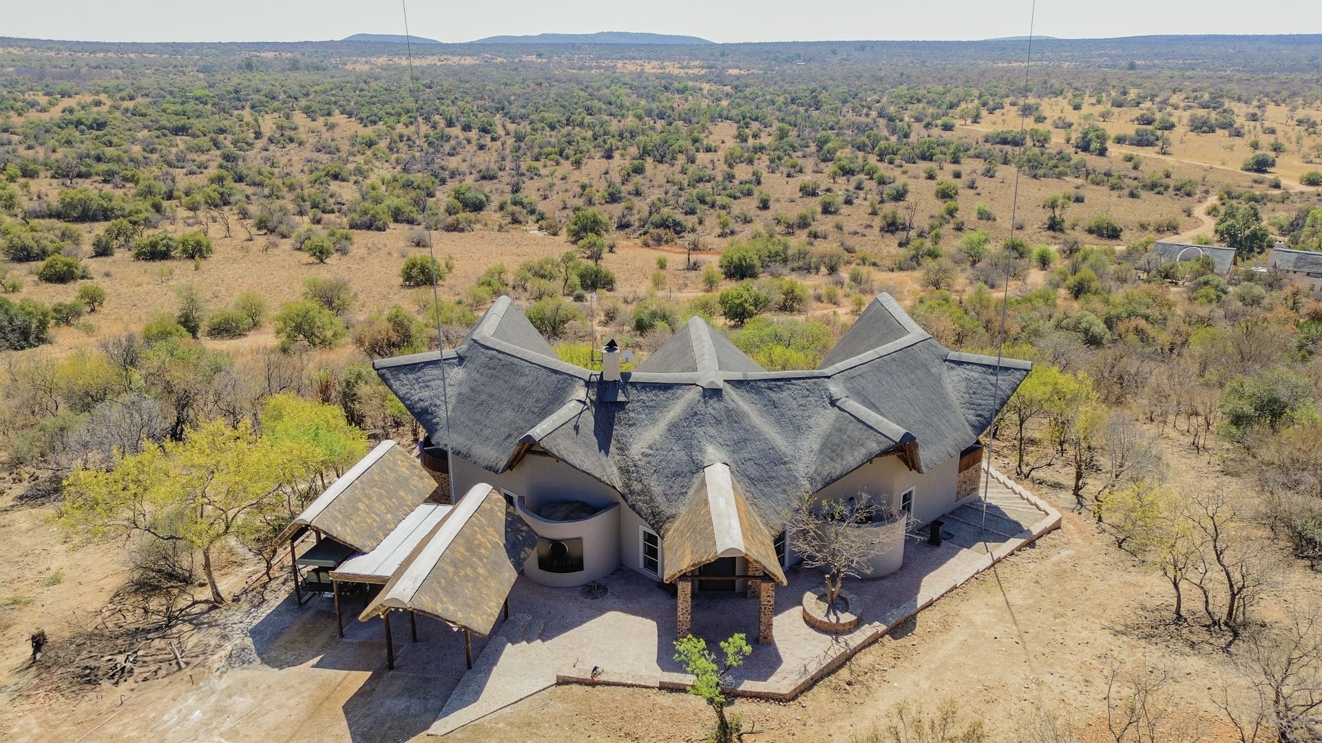 Aerial view of the thatched Tebuah Private Lodge surrounded by Waterberg bushveld