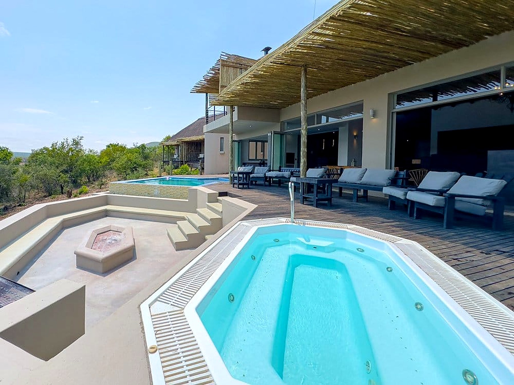 Jacuzzi and sunken firepit boma on the pool terrace at Sithrah Private Lodge