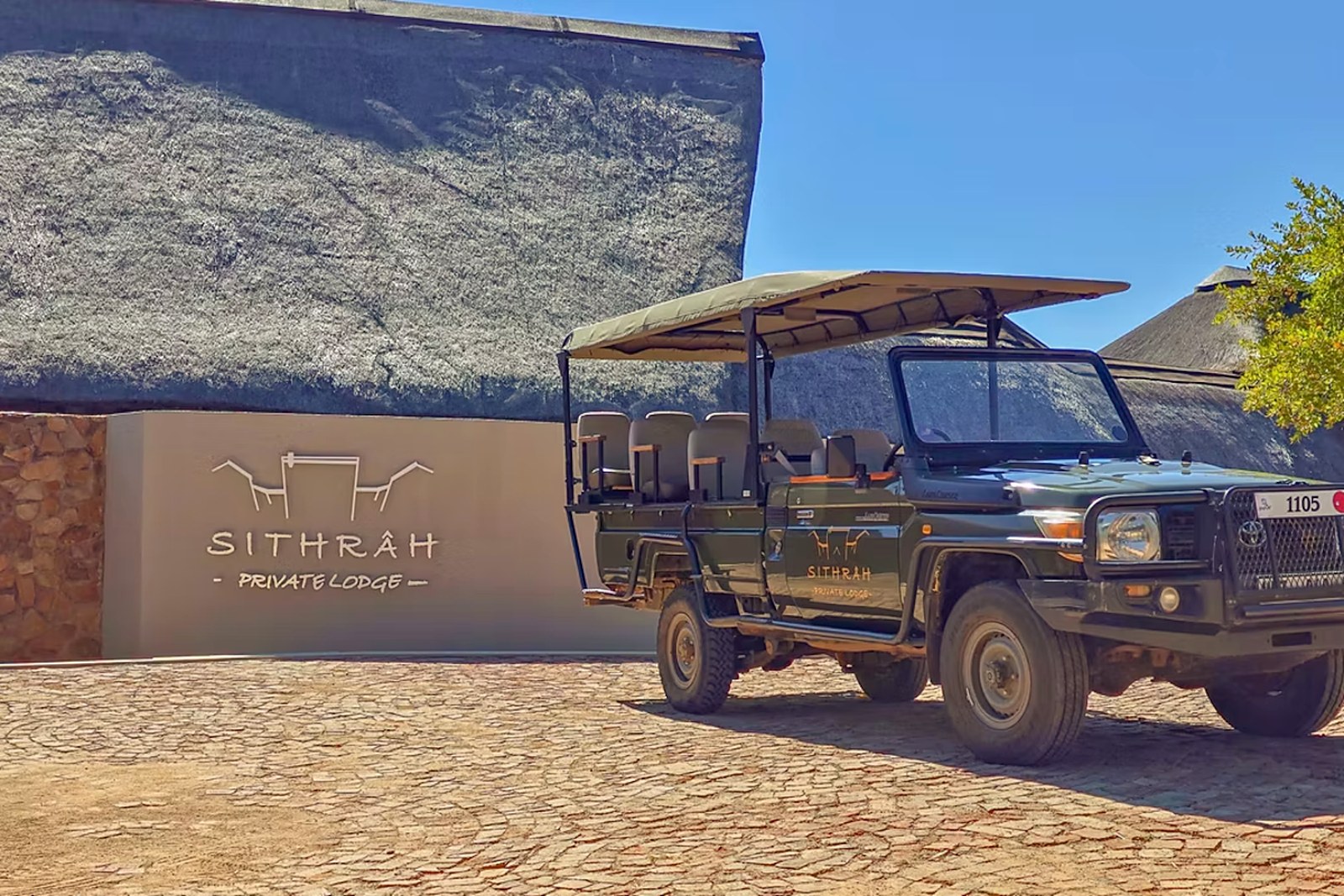 Sithrah branded open game viewing vehicle at the lodge entrance